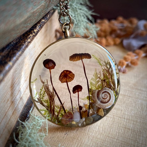 Real mushroom terrarium pendant. Botanical fairy forest necklace made from resin, moss, fern leaves, pebbles & fungi.