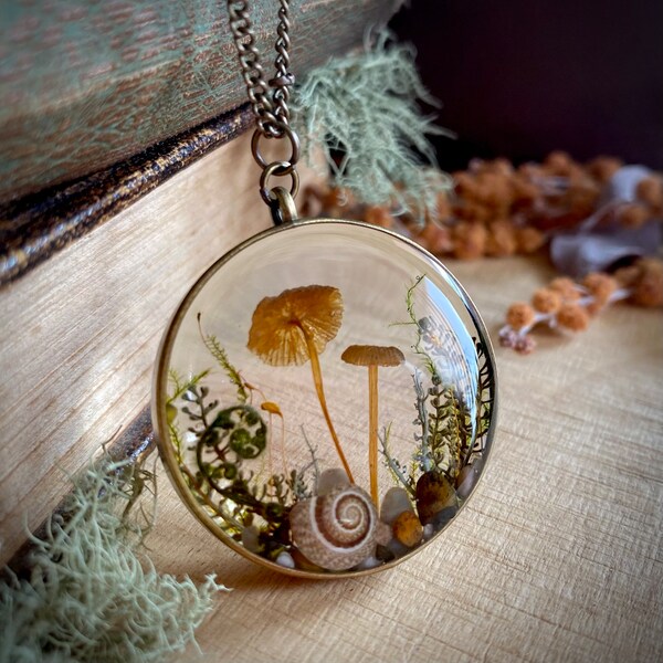 Real mushroom terrarium pendant. Botanical fairy forest necklace made from resin, moss, leaves, pebbles & fungi.