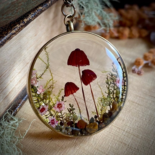 Real pink mushroom terrarium pendant. Botanical fairy forest necklace made from resin, moss, sand, leaves, flowers & fungi.