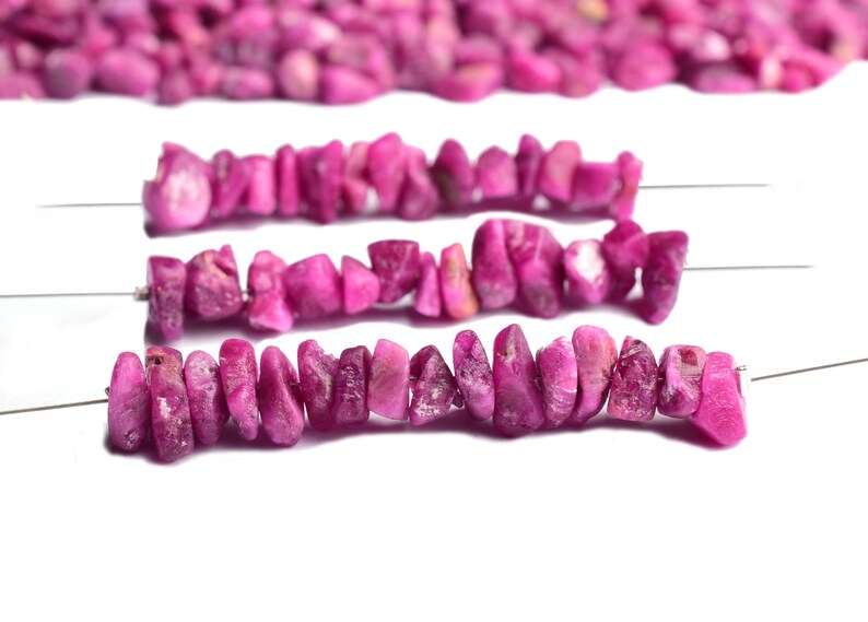 Close-up view of raw ruby showing deep red color and natural texture.