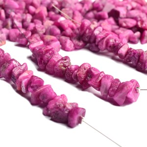 Group of rough ruby gemstones arranged to highlight color variation.