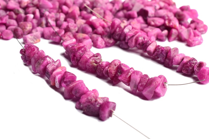 Group of rough ruby gemstones arranged to highlight color variation.