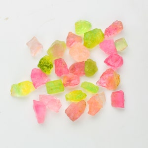 Close-up of mixed-color tourmaline rough gemstone pieces for jewelry making.