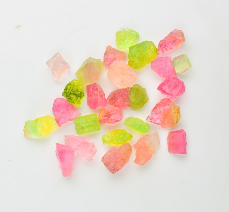 Close-up of mixed-color tourmaline rough gemstone pieces for jewelry making.
