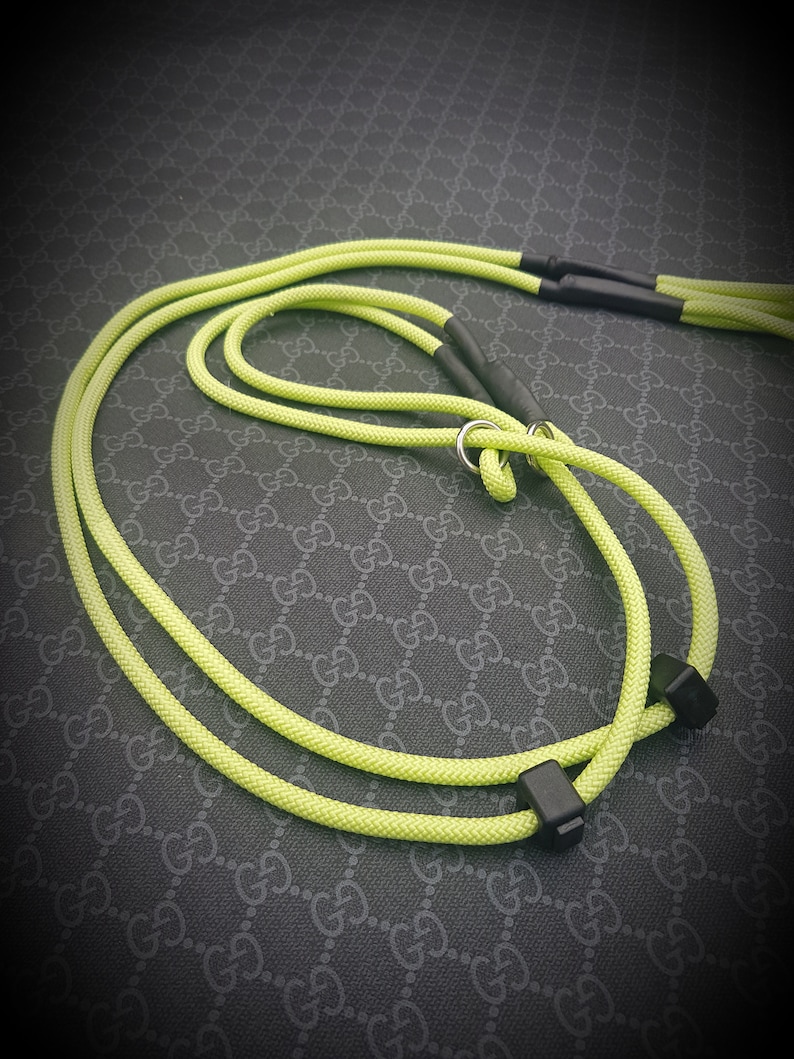May include: A bright yellow dog leash with black hardware. The leash is made of a thick, durable rope.