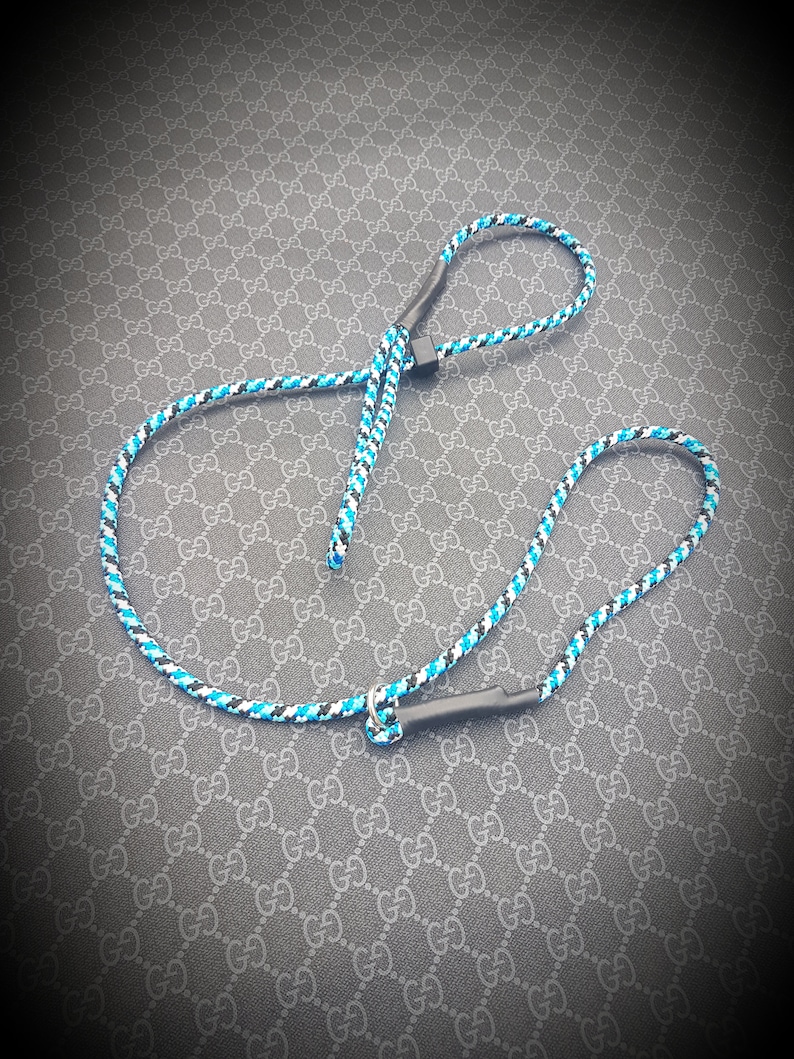 May include: A black and blue rope dog leash with a black handle.