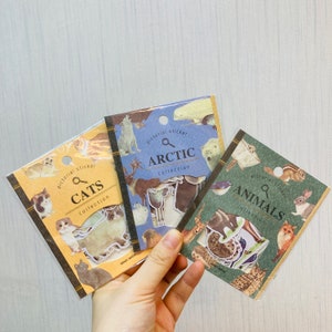 May include: Three sticker packs featuring different animal themes: cats, arctic animals, and general animals. Each pack has a magnifying glass icon and the words "pictorial sticker" and "collection".