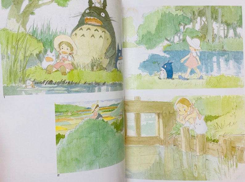 May include: Watercolor illustrations from a book featuring characters from the animated film "My Neighbor Totoro." The images depict scenes with Totoro, a large forest spirit, and a young girl in various outdoor settings, with a soft, whimsical style.