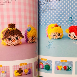 May include: A book with instructions on how to make bead sprites of Disney princesses. The book shows images of completed bead sprites of Rapunzel, Ariel, and Cinderella. The book is open to a page with the title "Aurora & Ariel".
