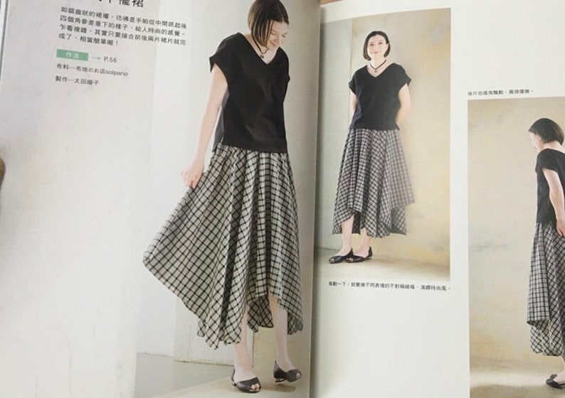 May include: A woman wearing a black V-neck top and a black and white plaid skirt. The skirt has an asymmetrical hemline. The image is from a fashion magazine.