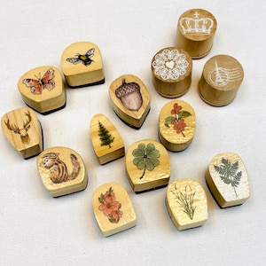 A  Wooden Rubber Stamp (Pick 1): bee, pine tree , mushroom, toadstool, candle, clover leaf, grass , acorn , pine cone, fruit, flower, leaf