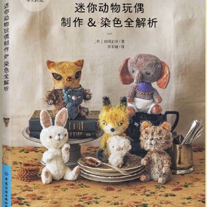 以下が含まれることがあります： 手作りのぬいぐるみを集めた本の表紙。猫、象、ウサギ、キツネ、そして小さな白い動物などがあります。本のタイトルは「ミニチュア動物のぬいぐるみ：製作と染色完全解析」です。