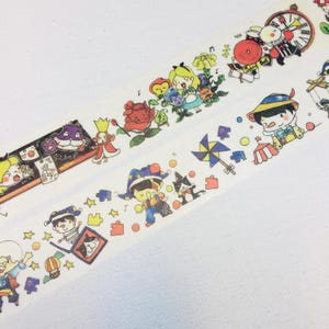 May include: Decorative washi tape featuring colorful illustrations of cartoon characters and whimsical elements. The tape includes images of Alice in Wonderland, Pinocchio, and other storybook characters. The tape is white with a repeating pattern.