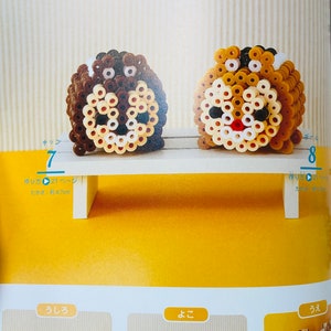 May include: A craft project featuring two bead sprites of Chip and Dale from Disney's Chip 'n Dale Rescue Rangers. The sprites are made with brown, beige, white, and black beads. The sprites are approximately 4.7 cm tall.