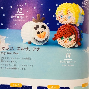 May include: A close-up of three bead sprites from the film Frozen. The characters are Olaf, Elsa, and Anna. Olaf is a snowman with a carrot nose and black eyes. Elsa has long blonde hair and a blue dress. Anna has long brown hair and a red dress. The beads are white, blue, red, yellow, and black.
