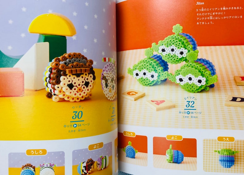 May include: A book with instructions on how to make bead sprites of popular characters, including Woody from Toy Story and an alien from Toy Story. The book includes a close-up image of a completed bead sprite of Woody and a close-up image of three completed bead sprites of aliens.