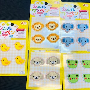 May include: A collection of adhesive patches featuring various animal designs, including monkeys, elephants, dogs, frogs, and chicks. Each patch is embroidered with detailed features and vibrant colors, perfect for decorating clothing or accessories.