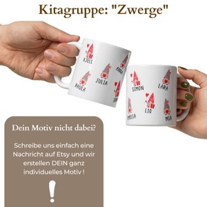 May include: Two white ceramic mugs with gnome illustrations and names. The mugs feature red and gray gnomes with heart accents. Text on the mugs includes names like Kjell, Paula, Julia, Anna, Simon, Lara, Emilia, Lio, and Mia. The text "Kitagruppe: Zwerge" is at the top.
