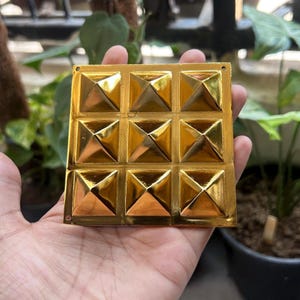 Navgraha Pyramid harmonizes cosmic energies, promoting balance and positivity in life. It aids in health, prosperity, and spiritual growth