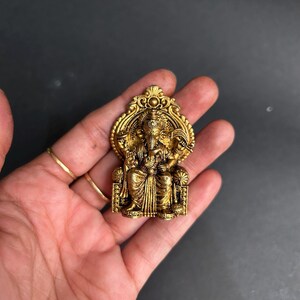 religious gift ganesha, ganpati idol for workplace, traditional brass statue, small brass deity idol, lord ganesha blessing idol, new car ganpati idol, ganesha idol with fine carving, mini ganesha brass statue, hindu gift item brass, brass ganesha home decor, small ganpati brass murti, ganesh idol spiritual gift, handcrafted brass ganesha, premium ganesha statue gift, decorative god idol, ethnic ganesha showpiece, brass murti for temple, gift for pooja lovers,