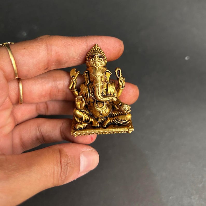 indian god murti for decor, ganpati idol for return gifts, ganesha sculpture for shelf, good luck ganpati idol, auspicious brass idol, ganesha idol for festive gift, spiritual decor for home, indian brass artifact, pooja room ganesha idol, ganpati murti small size, brass religious showpiece, brass ganesha lucky charm, handmade religious gift, traditional indian decor, office desk ganesha, diwali return gift ganpati, mini idol for car, compact brass ganesha, hindu god brass statue,