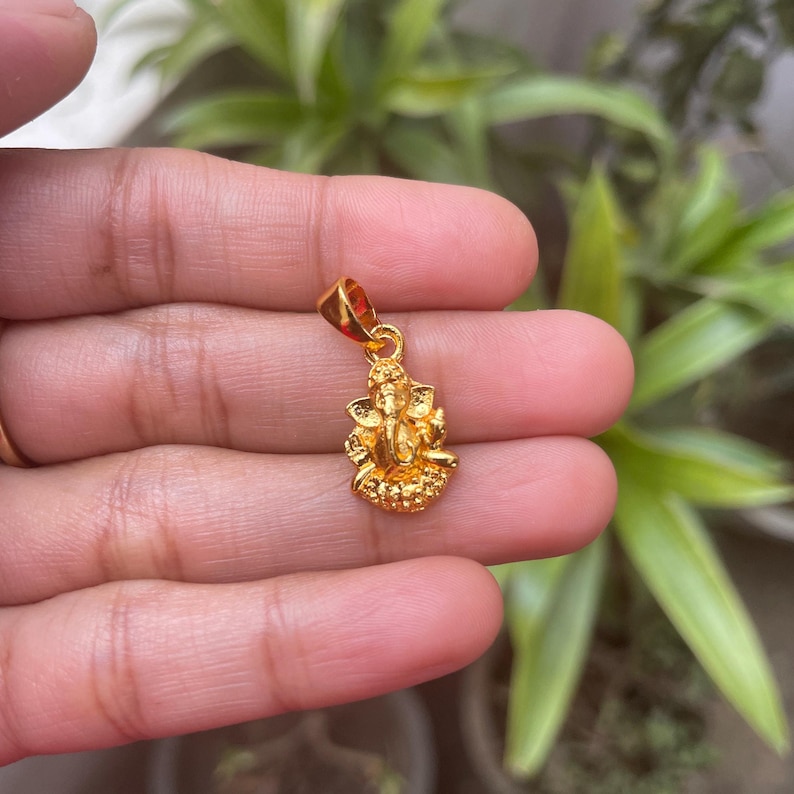 Ganesh Chaturthi jewelry
Ganesha blessed pendant
Small Ganesha necklace
Ganesh with trunk up
Prosperity amulet
Handmade Ganesha charm
Hindu blessings pendant
Ganesh god necklace
Divine Ganesha jewelry
Ganesha protection charm