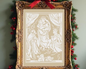 May include: A framed cross-stitch pattern featuring a white nativity scene on a tan background. The ornate gold frame is decorated with a red ribbon bow at the top, surrounded by green pine branches and red berries for a festive display.