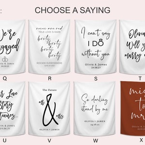 Pode incluir: Banners de tecido branco e ferrugem com texto preto. Apresentam frases como "We're Engaged", "I can't say I do without you" e "Will you marry me?" Ideais para decora&ccedil;&atilde;o de noivado ou casamento.
