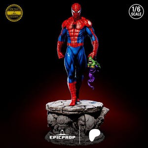 May include: A detailed Spider-Man statue in a dynamic pose, clad in a red and blue suit, holding a Green Goblin mask. The figure is on a stone-like base with sculpted faces. The statue is 1/6 scale.