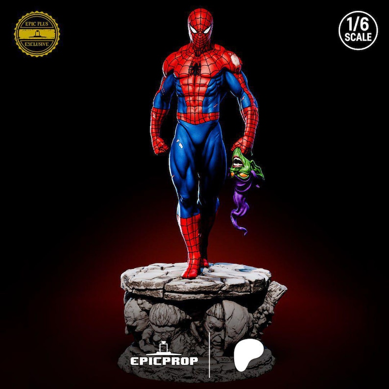 May include: A detailed Spider-Man statue in a dynamic pose, clad in a red and blue suit, holding a Green Goblin mask. The figure is on a stone-like base with sculpted faces. The statue is 1/6 scale.