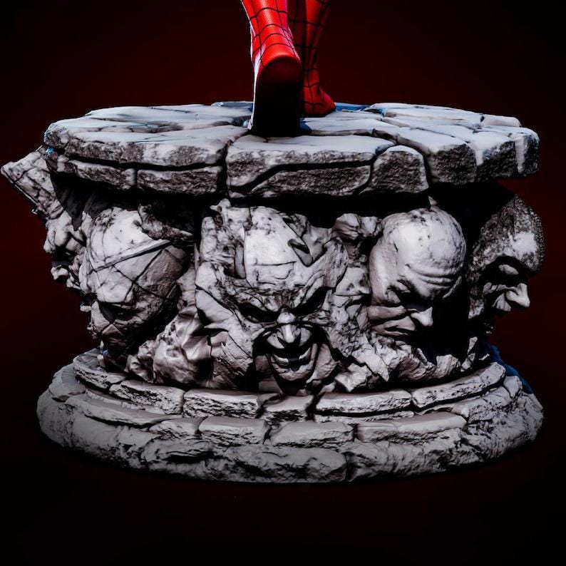 May include: A detailed statue base with a cracked stone appearance. The base features carved faces and a circular design. Red boots are visible on the top of the base. The statue base is a collectible item.
