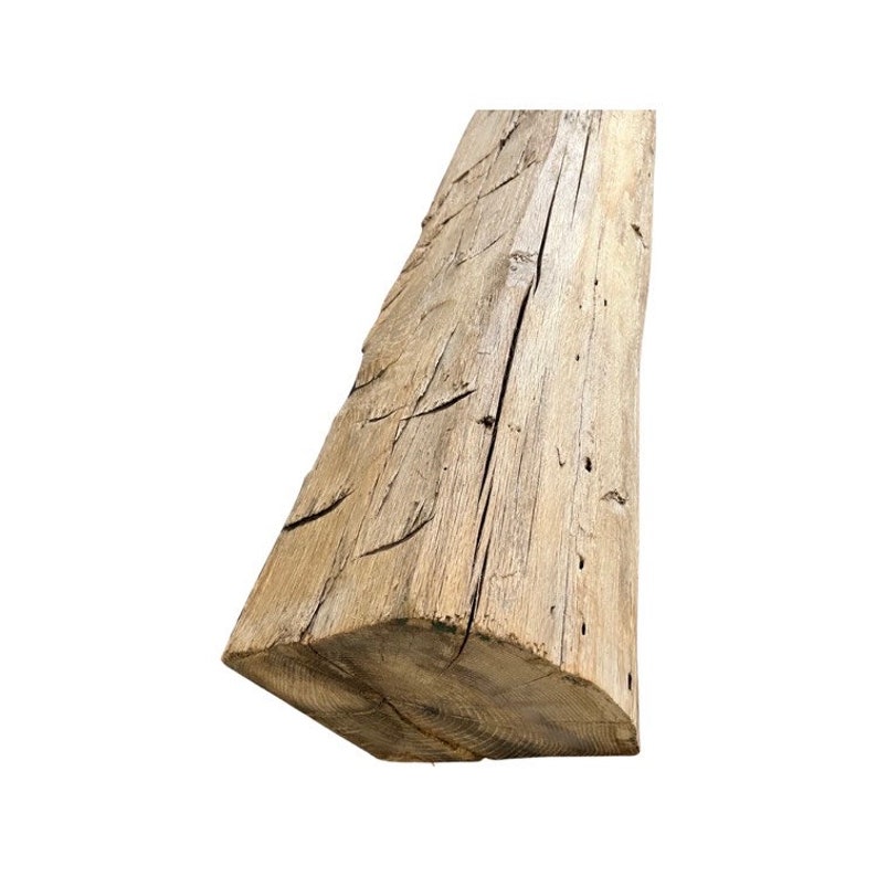 May include: A weathered, light brown wooden beam with a rough, rustic texture. The beam has a rectangular shape and is approximately 6 inches wide and 12 inches long.