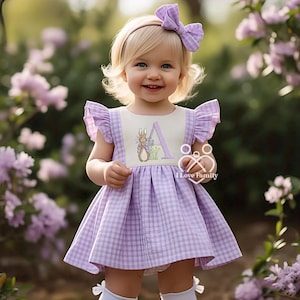May include: A little girl wearing a purple and white gingham dress with a Peter Rabbit embroidered design and the letter "A". She is wearing a white headband with a purple bow. The dress has a ruffle trim on the sleeves. The text "I Love Family" is visible on the dress.