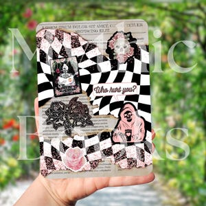 May include: A decorative card with a black and white chequered pattern, featuring a skull, roses, and the text "Who hurt you?". The card has a pink and black colour scheme with a grunge aesthetic.