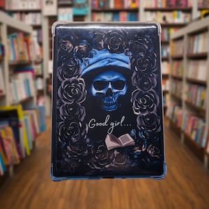 May include: A tablet case featuring a skull wearing a blue hat, surrounded by dark roses. The phrase "Good girl..." is written below the skull, with an open book graphic. The case has a clear border and is set against a blurred bookshelf background.