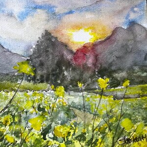 May include: Watercolor painting of a sunset over a field of yellow wildflowers. The sun is setting behind a mountain range, and the sky is a mix of blue, yellow, and orange. The flowers are in the foreground, and the mountains are in the background.