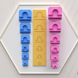 May include: A set of seven 3D printed Libra zodiac signs in various sizes. The signs are in blue, pink, and yellow. The signs are arranged in a vertical column, with the largest sign at the top and the smallest sign at the bottom.