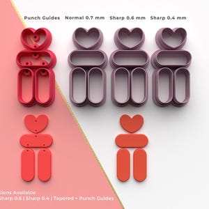 Puede incluir: Una colección de guías de punzonado rojas y moradas en forma de corazón y ovalada. El texto "Punch Guides" y "4 Cutting Options Available" es visible. Las guías de punzonado están dispuestas en un patrón de cuadrícula.