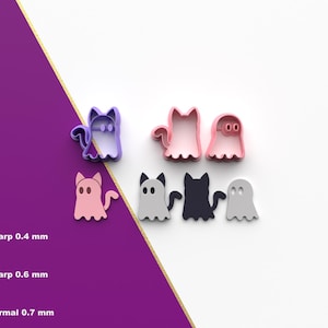 Könnte beinhalten: Eine Sammlung von Halloween-Ausstechern in Form von Geistern und Katzen. Die Ausstecher sind in verschiedenen Farben erhältlich, darunter Lila, Rosa, Grau und Schwarz. Das Bild enthält auch Text, der verschiedene Schneideschärfegrade angibt: 0,4 mm, 0,6 mm und 0,7 mm.