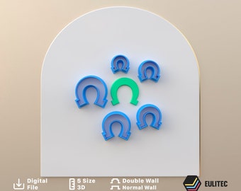 May include: Five blue horseshoe-shaped cookie cutters of different sizes, with one green horseshoe-shaped cookie cutter in the center.