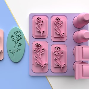 May include: A set of six pink silicone molds for making soap or resin. The molds are shaped like rectangles with a floral design. There are also two pink silicone molds for making soap or resin. The molds are shaped like bottles. The molds are on a purple background.