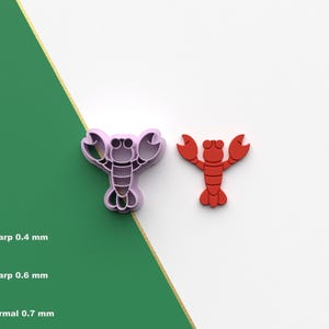 May include: Two lobster-shaped cookie cutters, one purple and one red, are displayed against a white and green background. The purple cutter is a mold, while the red one is a finished product. The image also shows different cutter sharpness options.