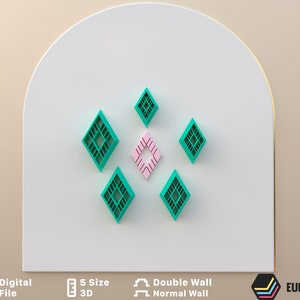 May include: A set of six 3D printed wall decor pieces in the shape of diamonds. Five of the diamonds are green and one is pink. The diamonds are arranged in a symmetrical pattern on a white background.