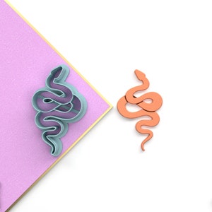 May include: Two 3D printed snake cookie cutters, one in light blue and one in orange. The cookie cutters are designed to create snake shapes for baking.