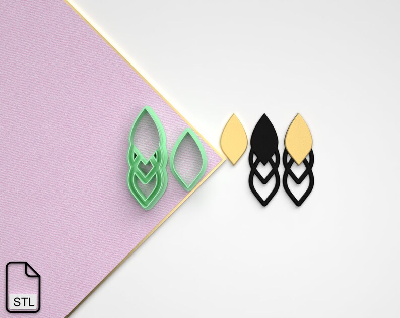 May include: A set of three layered earring designs in green, black, and yellow. The earrings are in the shape of a leaf with a geometric pattern. The design is shown on a white background.