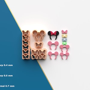 Peut inclure: Diverses découpoirs à biscuits roses, noirs et bruns en forme de nœuds et d'oreilles de souris. L'image montre également un graphique avec le texte "Sharp 0.4 mm", "Sharp 0.6 mm" et "Normal 0.7 mm".