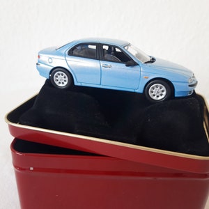 Light blue Alfa Romeo 1/43 scale with red advertising box, collectible cars