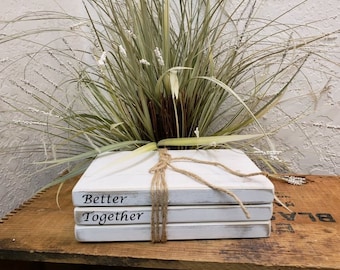 Stacked wood books, distressed white paint, "Better Together"