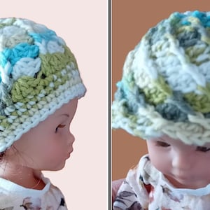 May include: A handmade crochet hat in a mix of colors, including white, light blue, green, and gray. The hat is displayed on a doll. The hat has a textured pattern and a brim. The hat is a unique accessory.