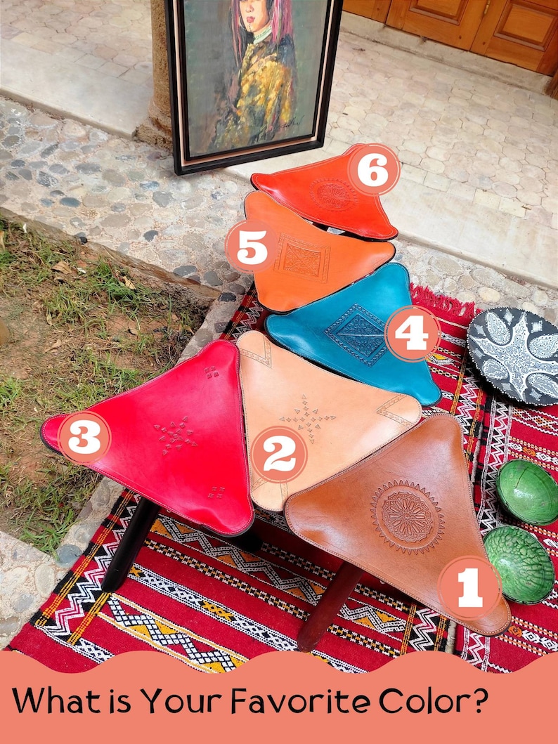 May include: Six colorful leather poufs in the shape of a triangle, arranged in a stack. The poufs are decorated with intricate patterns and are numbered 1 through 6. The poufs are sitting on a red and white patterned rug. The question "What is Your Favorite Color?" is written in white text on a pink background at the bottom of the image.